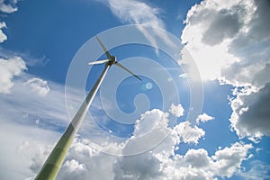 Wind turbines in the field and blue sky background