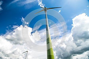 Wind turbines in the field and blue sky background