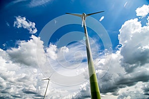 Wind turbines in the field and blue sky background