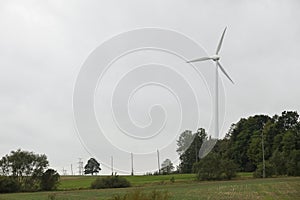 Wind turbines field in a stormy day with strong wind and rain. Wind farm eco field. Green ecological power