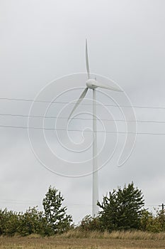 Wind turbines field in a stormy day with strong wind and rain. Wind farm eco field. Green ecological power