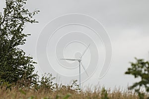 Wind turbines field in a stormy day with strong wind and rain. Wind farm eco field. Green ecological power