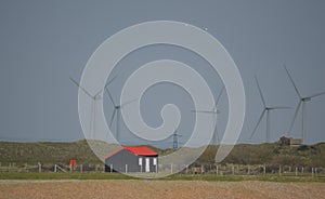 Wind Turbines and fishermans hut at Rye Harbour East Sussex UK