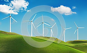 Wind turbines on green hills photo