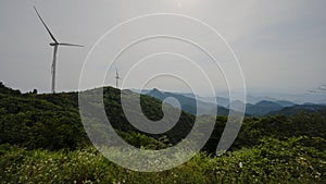 Wind turbines and hill scenery. Eco-friendly picture of electricity.