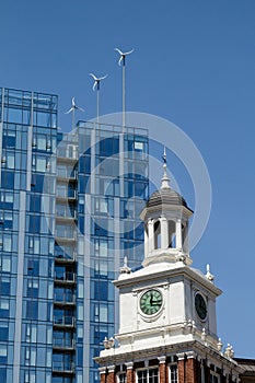 Wind turbines on modern building in Portland, OR behind old Telegram Building