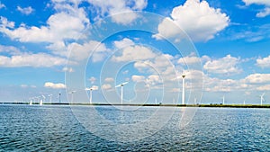 Wind Turbines, the modern Windmills, in a Wind Farm along the Shore of Veluwemeer