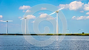 Wind Turbines, the modern Windmills, in a Wind Farm along the Shore of Veluwemeer