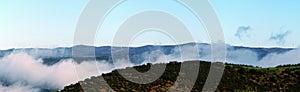 Wind turbines located on top of some hills. photo