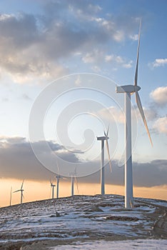 Wind turbines on a mountain with snow