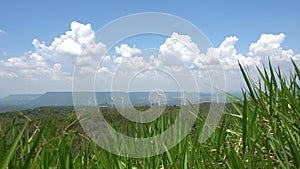 Wind turbines on mountain under cloud and blue sky