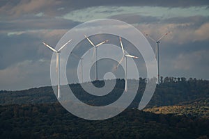 Wind turbines in the mountains under the cloudy sky