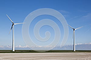 Wind turbines near the dike along the dutch Waddenzee