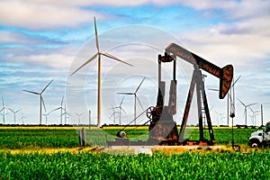 Wind turbines and oil rigs with large oil pump in West Texas creating large amounts of energy photo