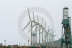 wind turbines on the pier with the port cranes