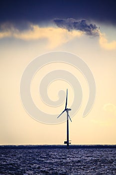 Wind turbines power generator farm along coast sea