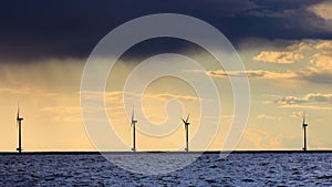 Wind turbines power generator farm along coast sea