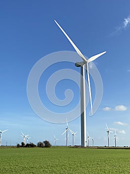 Wind turbines that produce electricity energy. Windmill Wind power technology productions Wind turbines in field