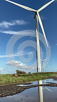 Wind turbines that produce electricity energy. Windmill Wind power technology productions Wind turbines in field