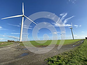 Wind turbines that produce electricity energy. Windmill Wind power technology productions Wind turbines in field