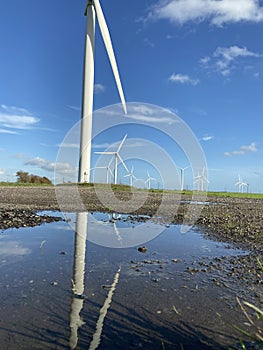 Wind turbines that produce electricity energy. Windmill Wind power technology productions Wind turbines in field