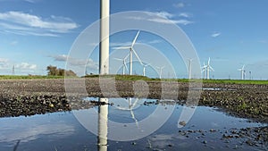 Wind turbines that produce electricity energy. Windmill Wind power technology productions Wind turbines in field