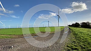 Wind turbines that produce electricity energy. Windmill wind power technology productions wind turbines in field