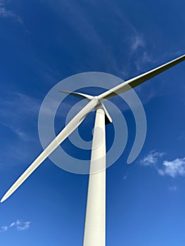 Wind turbines that produce electricity energy. Windmill Wind power technology productions Wind turbines in field