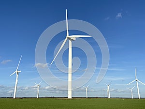 Wind turbines that produce electricity energy. Windmill Wind power technology productions Wind turbines in field