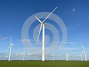 Wind turbines that produce electricity energy. Windmill Wind power technology productions Wind turbines in field