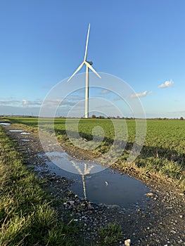 Wind turbines that produce electricity energy. Windmill Wind power technology productions Wind turbines in field