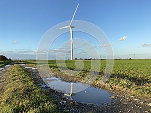 Wind turbines that produce electricity energy. Windmill Wind power technology productions Wind turbines in field