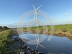 Wind turbines that produce electricity energy. Windmill Wind power technology productions Wind turbines in field