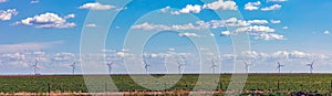 Wind turbines, renewable energy on a green field, spring day. Wind farm, West Texas, USA