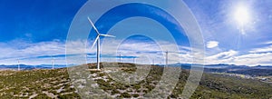 Wind turbines, renewable energy on a green hill. Wind farm