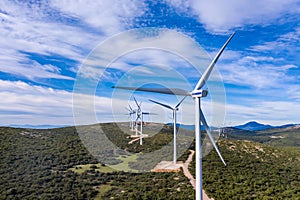 Wind turbines, renewable energy on a green hill. Wind farm