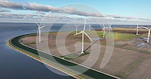 Wind turbines, renewable and green energy. Windfarm in Flevoland, Almere, The Netherlands. Birds eye aerial drone view.