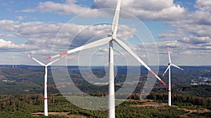 Wind turbines rotating in the sun filmed with sideways movement  in 4k