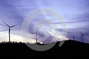 Wind turbines running at sunset in La Puebla de GuzmÃÂ¡n, Huelva, Andalusia, Spain.