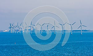 Wind turbines in sea in Copenhagen, Denmark. Offshore wind farm for renewable sustainable and alternative energy production. Green