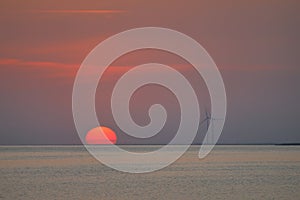 Wind turbines on the seacost during summer sunset