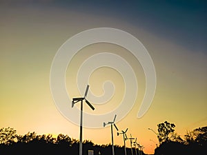 Wind turbines and sky at sunset