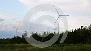 Wind turbines spinning in the cloudy wind during a sunset in the Black Forest
