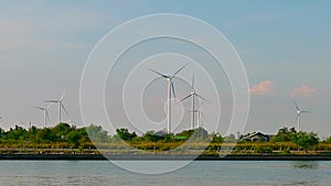 Wind turbines are spinning during the setting sun. Video time lapse 4K