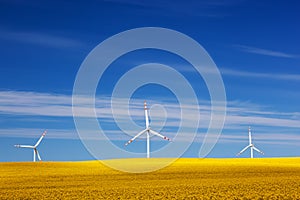 Wind turbines on spring field. Alternative, clean energy