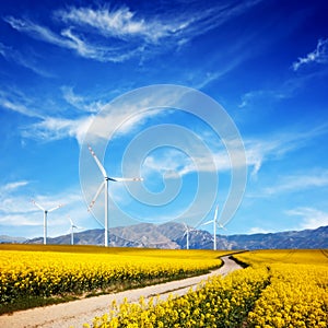 Wind turbines on spring field. Alternative, clean energy