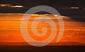 Wind turbines at sunset with a dramatic sky. German landscape near Mannheim