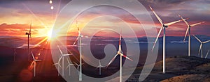 Wind Turbines At Sunset In Rural Mountain Landscape