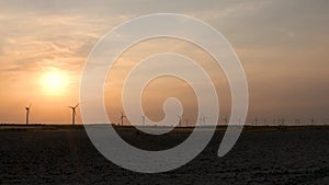 Wind turbines at the sunset in the wind farm in Zaragoza, Spain.