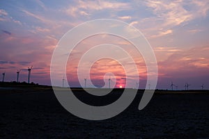 Wind turbines at the sunset in the wind farm in Zaragoza, Spain.